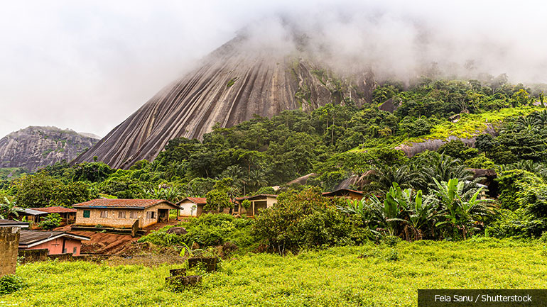 Houses and forest against Idanre Hill near Akure, Nigeria.